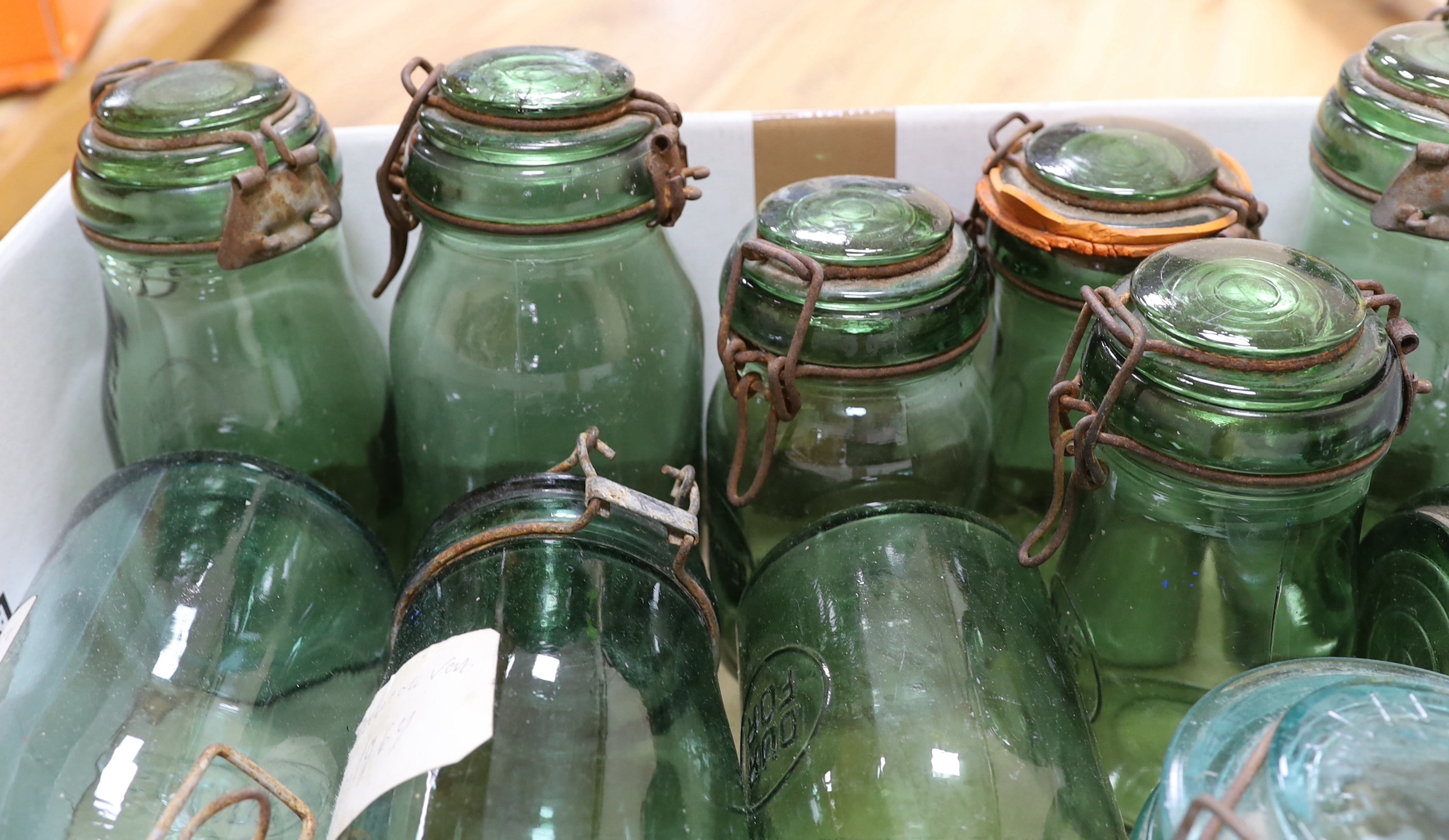 A collection of various sized French green glass storage jars (12)